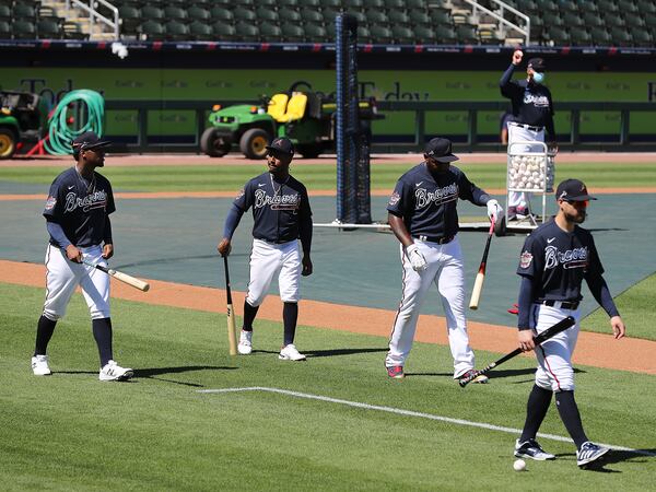 Braves players Ronald Acuna (from left), Ozzie Albies, Marcell Ozuna and Ender Inciarte finish up batting practice during the first full-squad workout Tuesday, Feb. 23, 2021, at CoolToday Park in North Port, Fla. (Curtis Compton / Curtis.Compton@ajc.com)