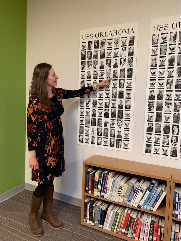 Carrie LeGarde, who has been working on the Oklahoma Project to identify hundreds of human remains recovered from the U.S.S. Oklahoma, sunk at Pearl Harbor, points out Georgian Gene Blanchard among the photos of sailors killed. Blanchard was identified in early 2021.