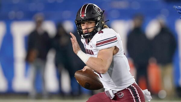 South Carolina quarterback Luke Doty (4) scrambles with the ball against Kentucky, Saturday, Dec. 5, 2020, in Lexington, Ky. (Bryan Woolston/AP)