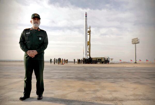 In this photo released by Sepahnews, Gen. Amir Ali Hajizadeh, the head of the Revolutionary Guard’s aerospace division, stands in front of an Iranian rocket carrying a satellite.