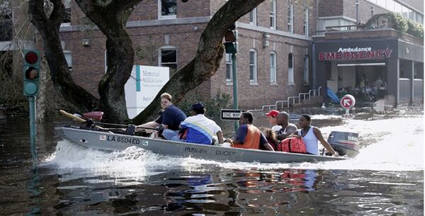 Patients and staff of the Memorial Medical Center in New Orleans are evacuated by boat after flood waters surrounded the facility (AP Photo/Bill Habert)