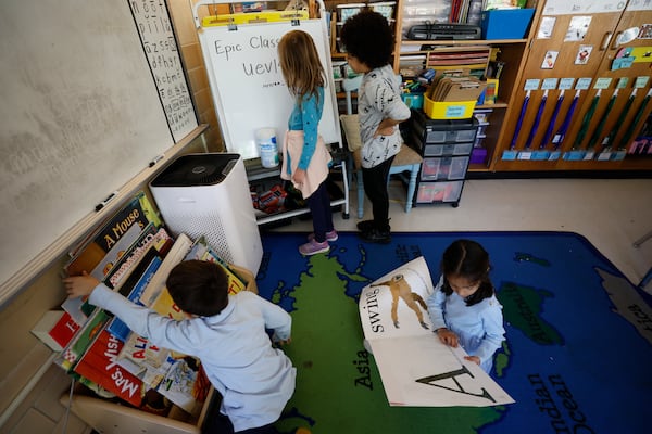 First grade students are seen participating in a class with an air purifier cleaning the air at Ashford Park Elementary School on Thursday, Nov. 2, 2023. (Miguel Martinez / miguel.martinezjimenez@ajc.com)