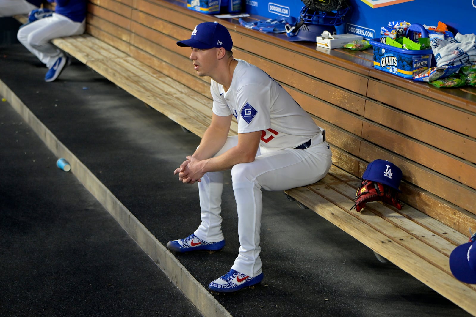 FILE - Los Angeles Dodgers' Walker Buehler sits in the dugout after the first inning of a baseball game against the Seattle Mariners, Tuesday, Aug. 20, 2024, in Los Angeles. (AP Photo/Jayne-Kamin-Oncea, File)