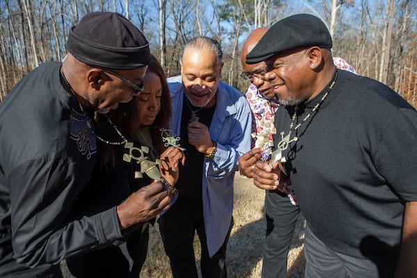 Siblings John Taylor (from left), Wanda Welcome, Tawala Kweli, Lewis Thompson and Percival Lammie show off their matching necklaces for a photo together during a family reunion on Wednesday, December 27, 2022, in Suwanee. At the event, Thompson, visiting from Australia, met four of his seven biological siblings for the first time. The necklaces are meant to represent family and tribal unity. CHRISTINA MATACOTTA FOR THE ATLANTA JOURNAL-CONSTITUTION. 