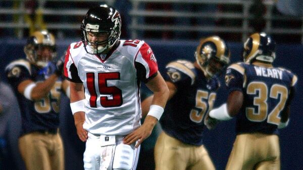 The Rams (background) celebrate in the end zone as Falcons backup quarterback Kurt Kittner walks off the field after throwing a fourth-quarter interception that was returned for a touchdown Monday, Oct. 13, 2003, at Edward Jones Dome in St. Louis. (Curtis Compton/Curtis.Comtpon@ajc.com)