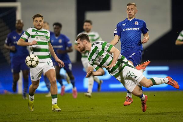 Celtic's Anthony Ralston jumps to intercept the ball during the Champions League opening match between Dinamo Zagreb and Celtic at Maksimir Stadium in Zagreb, Croatia, Tuesday, December 10, 2024. (AP Photo/Darko Vojinovic)