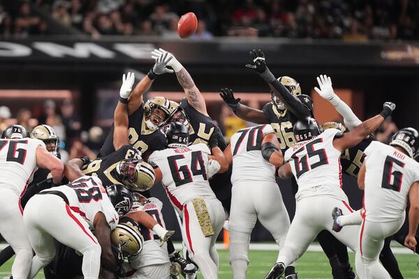 New Orleans Saints defensive end Payton Turner, center, and defensive end Carl Granderson (96), try to block a field goal by Atlanta Falcons place kicker Younghoe Koo (6) in the first half of an NFL football game in New Orleans, Sunday, Nov. 10, 2024. (AP Photo/Gerald Herbert)