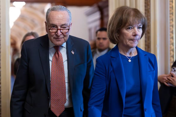 Senate Minority Leader Chuck Schumer, D-N.Y., walks with Sen. Tina Smith, D-Minn., right, as Senate Democrats gather behind closed doors to mount a last-ditch protest over a Republican-led spending bill that already passed the House, at the Capitol in Washington, Thursday, March 13, 2025. (AP Photo/J. Scott Applewhite)