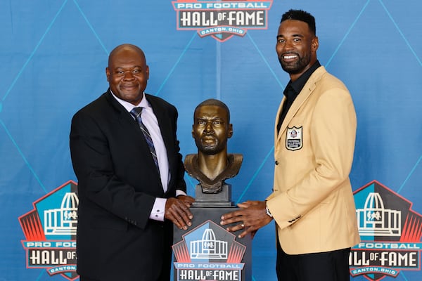 Calvin Johnson, a member of the Pro Football Hall of Fame Class of 2021 (right), poses with his presenter Derrick Moore, the former character development coach at Georgia Tech, during the induction ceremony at the Pro Football Hall of Fame, Sunday, Aug. 8, 2021, in Canton, Ohio. (Ron Schwane/AP)