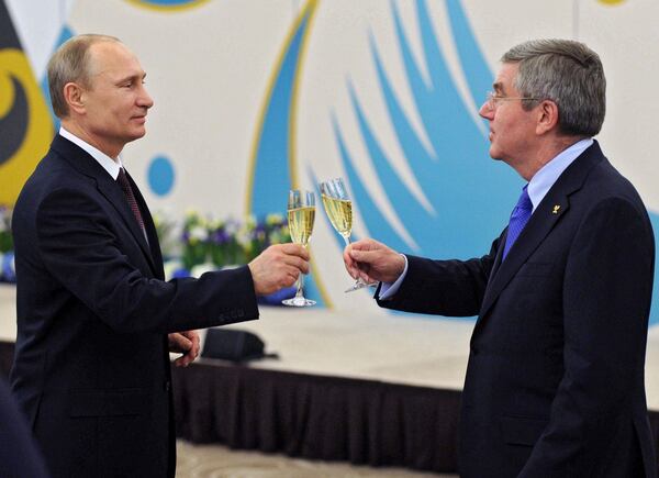 FILE - Russian President Vladimir Putin, left, toasts a glass of champagne with the International Olympic Committee President Thomas Bach during the official reception of IOC for Sochi 2014 Winter Olympics organizing committee on Monday, Feb. 24, 2014, in Sochi, Russia. (AP Photo/RIA Novosti Kremlin, Mikhail Klimentyev, Presidential Press Service, File)