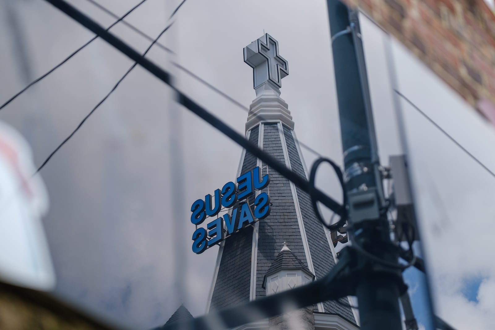 Big Bethel AME Church in Atlanta is reflected from a panel on 229 Auburn Avenue on Wednesday, July 20, 2022. The 229 Auburn Avenue building is said to have housed the first Black bank in Georgia, is pictured(Arvin Temkar / arvin.temkar@ajc.com)