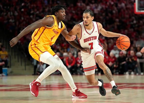 Iowa State guard Demarion Watson (4) defends against Houston guard Milos Uzan (7) during the second half of an NCAA college basketball game in Houston, Saturday, Feb. 22, 2025. (AP Photo/Karen Warren)