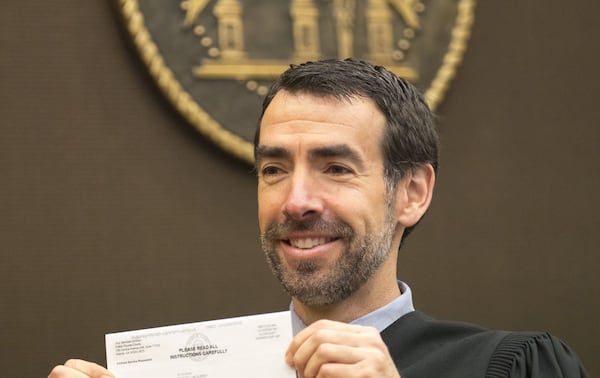 03/26/2018 — Atlanta, GA - Fulton County Chief Judge Robert McBurney shows off his own jury summons to the jury before the start of the tenth day of trial for Tex McIver at the Fulton County Courthouse, Monday, March 26, 2018. ALYSSA POINTER/ALYSSA.POINTER@AJC.COM