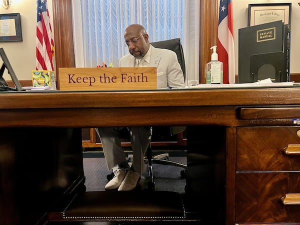 U.S. Sen. Raphael Warnock, who's also a senior pastor, works in his Washington office. The Atlanta Democrat delivered the opening prayer in the Senate chambers on Tuesday.