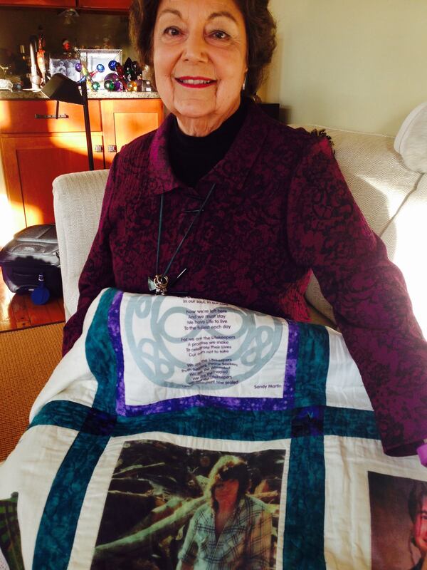 Iris Bolton shows off a quilt bearing the images of suicide victims, including her son, Mitch, who died in 1977. Bolton often shares her story to raise awareness about suicide and encourage survivors to work through their grief. Gracie Bonds Staples/AJC.Com