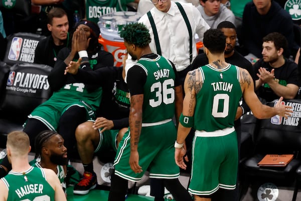 Boston Celtics guard Marcus Smart (36) and forward Jayson Tatum (0) walks to the bench after being taken out of the game during the second half in Game 7 of the NBA basketball Eastern Conference finals against the Miami Heat Monday, May 29, 2023, in Boston. (AP Photo/Michael Dwyer)