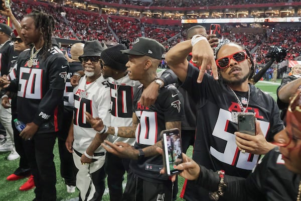 Hip Hop artists take the field to form a tunnel for the entrance of the Atlanta Falcons. The Falcons celebrated Hip-Hop 50 with performances and appearances during their NFL football game between the Atlanta Falcons and the New Orleans Saints in Atlanta on Sunday, Nov. 26, 2023.   (Bob Andres for the Atlanta Journal Constitution)