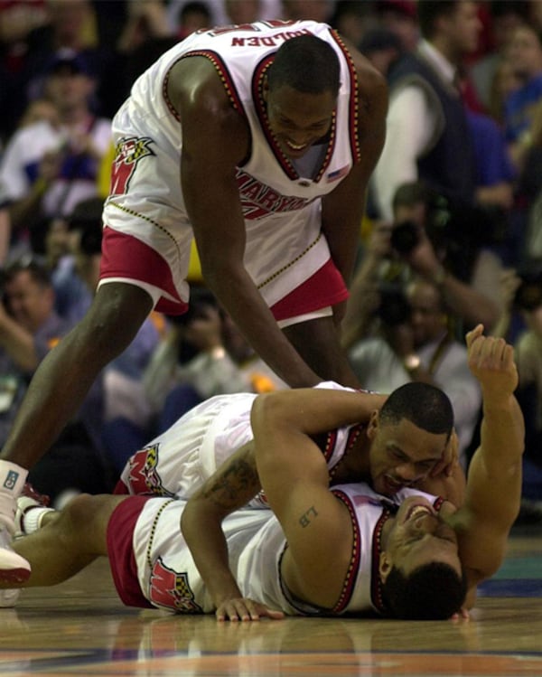 Maryland players Tajh Holden, Juan Dixon (middle) and Lonny Baxter celebrate after Maryland wins the NCAA Championship game over Maryland Monday, April 1, 2002, at the Georgia Dome in Atlanta.