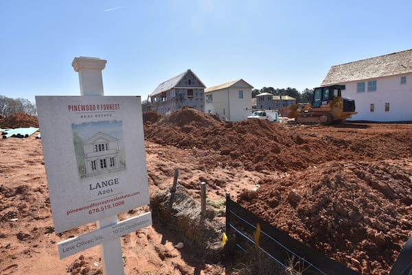 Construction crews work on Pinewood Forest houses, and townhomes, part of the first phase of the 234-acre development.