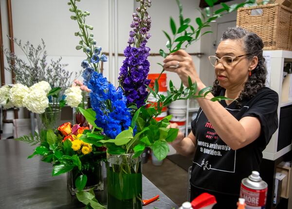 Floral Matters owner Jeanna Bailey works on an arrangement for a customer at her shop located inside the One Atlantic Center office tower in Midtown Atlanta.  STEVE SCHAEFER FOR THE ATLANTA JOURNAL-CONSTITUTION