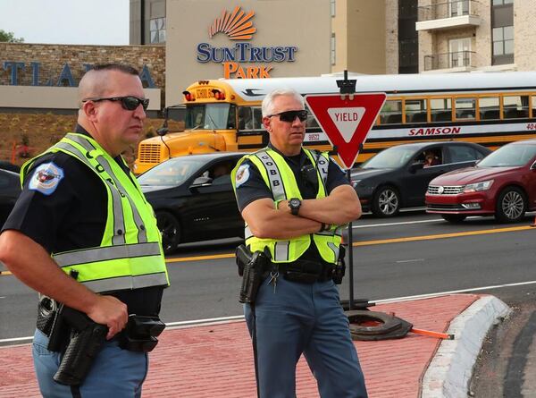  Two Cobb County police officers work traffic control outside of SunTrust Park during a recent game. Cobb taxpayers will spend an estimated $900,000 a year for traffic management at the new stadium.