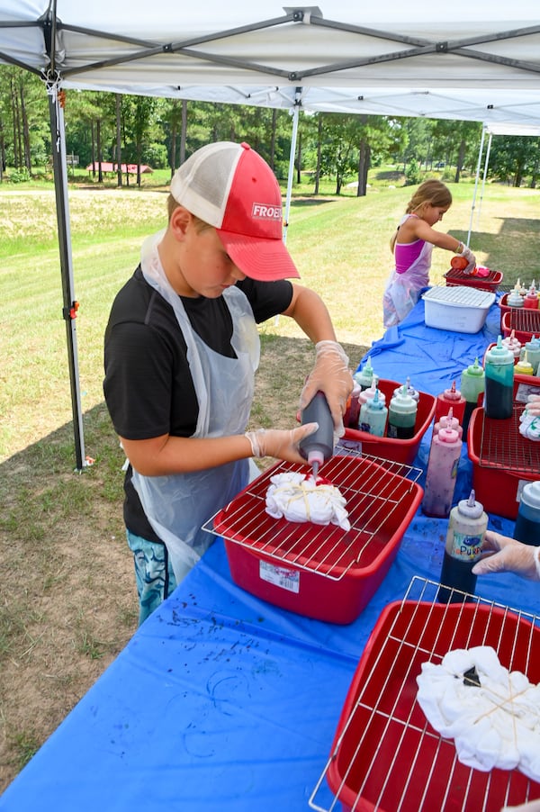 Campers work on tie-dye creations during a recent session of Camp Kudzu, for kids and teens living with Type 1 diabetes. Jennie Clayton/Special to the AJC