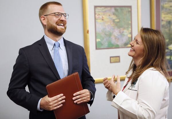 Dr. Kent Brantly has a word with Sharon Vanairsdale, a member of the nursing staff that assisted with his care, before the event. She is now the director for Emory’s Serious Communicable Diseases Program. Members of the Emory University Hospital medical team who successfully treated the first patients with Ebola virus disease in the United States reunited with former patients Dr. Kent Brantly, and Nancy Writebol on Friday, Aug. 2. Bob Andres / robert.andres@ajc.com