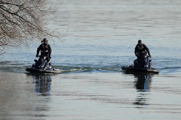 Search and rescue efforts are seen around a wreckage site in the Potomac River from Ronald Reagan Washington National Airport, early Thursday morning, Jan. 30, 2025, in Arlington, Va. (AP Photo/Carolyn Kaster)