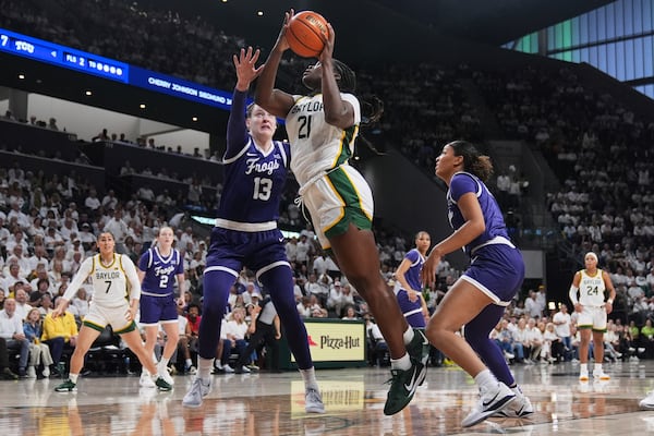 Baylor center Aaronette Vonleh (21) takes a shot as TCU's Sedona Prince (13) and Aaliyah Roberson, right, defend in the first half of an NCAA college basketball game in Waco, Texas, Sunday, March 2, 2025. (AP Photo/Tony Gutierrez)