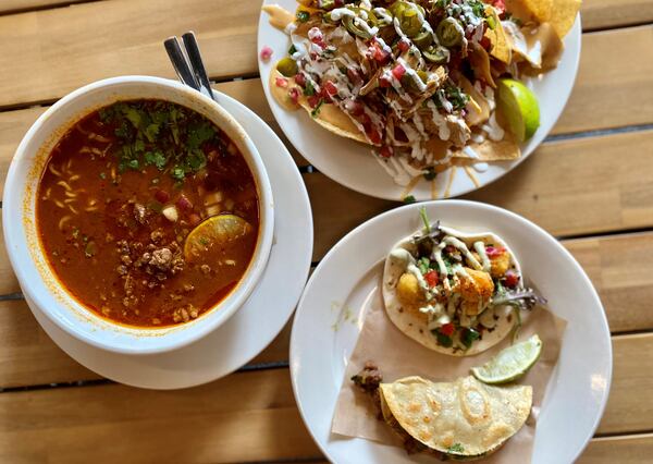 A feast from Pretty Little Tacos: (clockwise starting from the left) spicy birria ramen with steak, chicken nachos and a Creole cauliflower and steak taco. (Wendell Brock for The Atlanta Journal-Constitution)