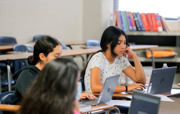 Student Melanie Ortiz works on a computer during Gwinnett County's Hispanic Mentoring Program summer camp at Meadowcreek High School on Wednesday, July 14, 2021. (Christine Tannous / christine.tannous@ajc.com)