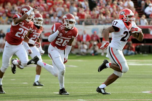 Georgia running back Nick Chubb (27) outruns Arkansas cornerback Jared Collins (29), safety Rohan Gaines (26) and safety Alan Turner (27) for a 43-yard touchdown rush in the second quarter of an NCAA college football game in Little Rock, Ark., Saturday, Oct. 18, 2014. (AP Photo/David Quinn) Nick Chubb runs to daylight, of which there was much. (