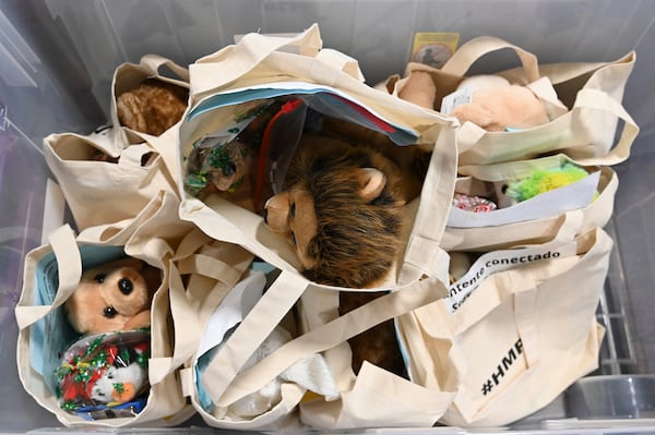 December 9, 2020 Lilburn - Gwinnett County Public Schools' Hispanic Mentoring Program staff prepare bags of two science experiments, that students are supposed to do at home, and Christmas gift at Plaza Las Americas in Lilburn on Wednesday, December 9, 2020. (Hyosub Shin / Hyosub.Shin@ajc.com)