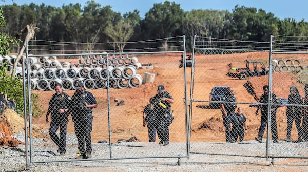 Protesters gathered on Constitution Road (shown here) after five individuals were arrested Thursday morning, Sept. 7, 2023, at the site of Atlanta's proposed public safety training center after chaining themselves to construction equipment in an effort to halt work. According to the Atlanta Police Department, the training center opponents broke into the construction site off Constitution Road around 9:30 a.m. Thursday. (John Spink/The Atlanta Journal-Constitution/TNS)