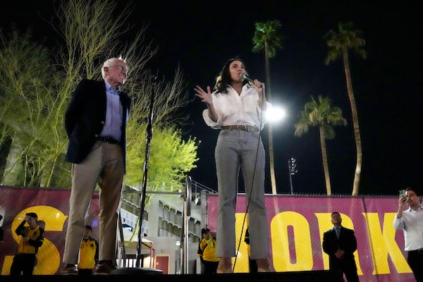 Sen. Bernie Sanders, I-Vt., and Rep. Alexandria Ocasio-Cortez, D-N.Y., speak outside of Arizona State University to the overflow crowd that did not get inside the arena, during a "Fighting Oligarchy" tour event Thursday, March 20, 2025, in Tempe, Ariz. (AP Photo/Ross D. Franklin)