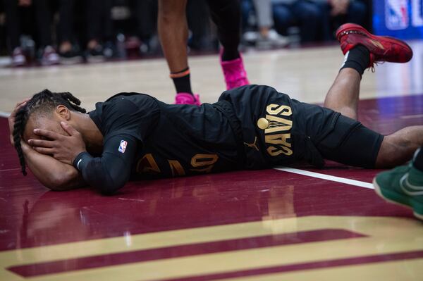 Cleveland Cavaliers' Darius Garland reacts after an injury during the first half of an NBA basketball game against the New York Knicks in Cleveland, Friday, Feb. 21, 2025. (AP Photo/Phil Long)