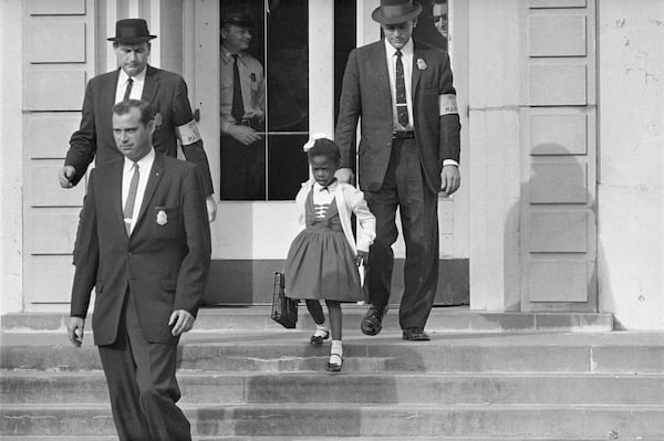 U.S. Deputy Marshals escort 6-year-old Ruby Bridges from William Frantz Elementary School in New Orleans, in November 1960. AP FILE Photo