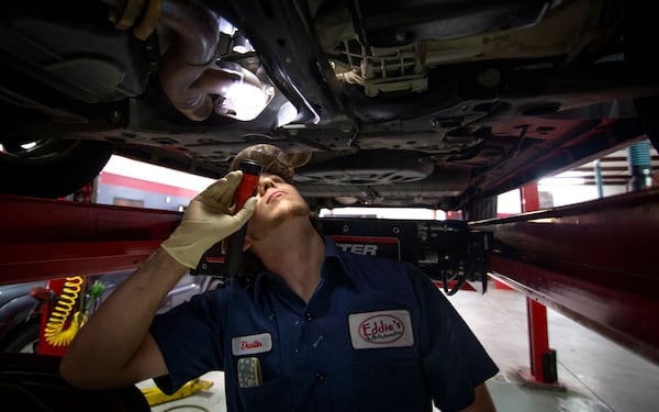 Dustin Monacelli inspects a customers’ car at Eddie’s Automotive Service in Lilburn on May 13, 2020. STEVE SCHAEFER / SPECIAL TO THE AJC