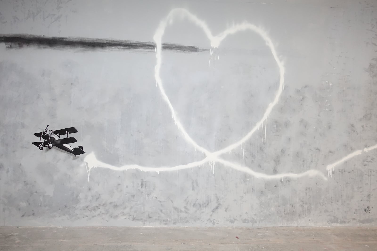 Twenty-three Banksy images such as "Love Plane" have been recreated as murals by a team of local artists including Big Papito, GhostKingOG and Spraykid for "Without Limits."
Courtesy of Nicholas Wolaver for SEE Global Entertainment