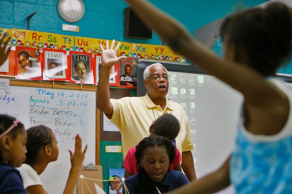  Teacher Rudoph Liggins at Chapel Hill Elementary in DeKalb County gives instructions for building a bridge out of spaghetti and marshmallows, part of an experiment for a class segment on types of bridges in this AJC file photo.   