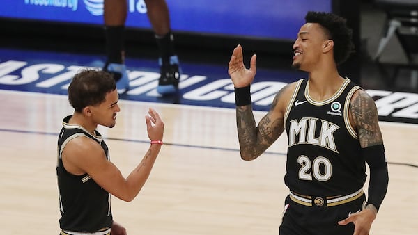 Atlanta Hawks guard Trae Young and forward John Collins get together to begin the game against the Milwaukee Bucks in Game 6 of the NBA Eastern Conference Finals on Saturday, July 3, 2021, in Atlanta.   “Curtis Compton / Curtis.Compton@ajc.com”