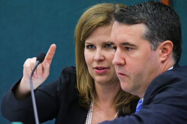 September 30, 2014 Atlanta: Commission Chairwoman, Hillary Stringfellow (left) points out some information to fellow commissioner, Lawton Jordan (right) at the State Ethics Commission meeting, formally called Georgia Government Transparency &amp; Campaign Finance Commission at the Coverdell Legislative Office Building at 18 Capitol Square Tuesday, Sept. 30, 2014. JOHN SPINK/JSPINK@AJC.COM