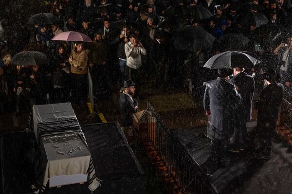 A rabbi delivers a eulogy next to the coffin containing the remains of Israeli-Moldovan Rabbi Zvi Kogan in Kfar Chabad, Israel, on Monday, November 25, 2024. Kogan, 28, an ultra-Orthodox rabbi, was killed last week in Dubai, where he ran a kosher grocery store. Israelis have increasingly traveled to Dubai for business and tourism since the two countries established diplomatic ties through the 2020 Abraham Accords.(AP Photo/Ohad Zwigenberg)