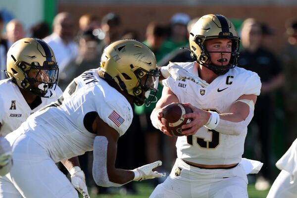 Army quarterback Bryson Daily (13) fakes a hand off to running back Kanye Udoh (6) in the first half of an NCAA football game against North Texas Saturday, Nov. 9, 2024, in Denton, Texas. (AP Photo/Richard W. Rodriguez)