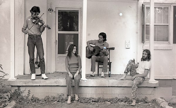 Musicians Townes Van Zandt (from left), Susanna Clark, Guy Clark and Daniel Antopolsky play some tunes on the Clarks’ porch in Nashville in 1972. (Courtesy of Al Clayton)