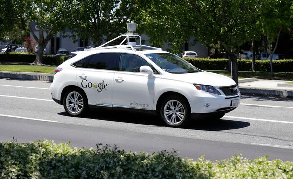 FILE - In this May 13, 2014 file photo, a Google self-driving car goes on a test drive near the Computer History Museum in Mountain View, Calif. Self-driving cars are expected to usher in a new era of mobility, safety and convenience. The problem, say transportation researchers, is that people will use them too much. (AP Photo/Eric Risberg, File)