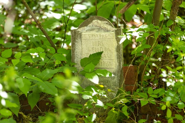 A gravestone of one of Audrey Collins’ relatives in Piney Grove Cemetery in Buckhead on Wednesday, May 3, 2023. Audrey and her sister Rhonda Jackson are trying to restore the ancient cemetery, which is where about 30 of their family members are buried. (Arvin Temkar / arvin.temkar@ajc.com)