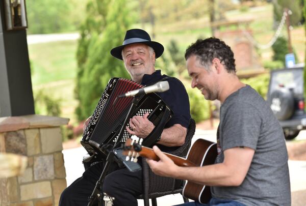 Owner Bob Miller (left) plays accordion with musician Christian Jones at Yonah Mountain Vineyards in Cleveland. It is the first winery in Georgia to implement a major solar power initiative. HYOSUB SHIN / HSHIN@AJC.COM