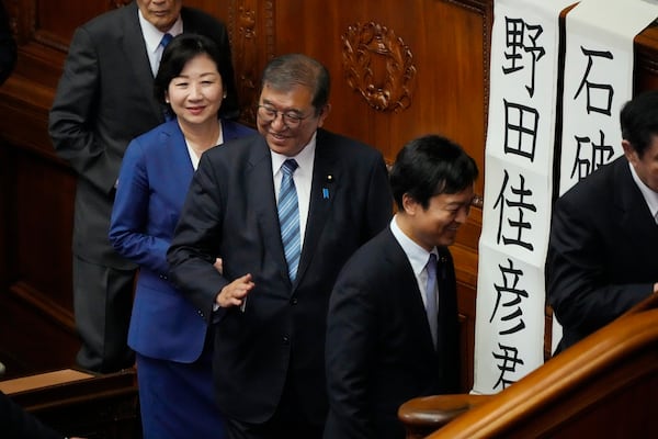 Japanese Prime Minister Shigeru Ishiba, center, queues for a runoff vote for a new prime minister at a special parliamentary session of the lower house Monday, Nov. 11, 2024, in Tokyo. (AP Photo/Eugene Hoshiko)