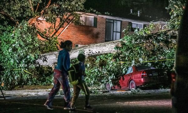 A tree fell on a building and crushed parked cars at the Valley Oaks Apartments on Johnson Road when storms moved through the Chamblee area Tuesday. 